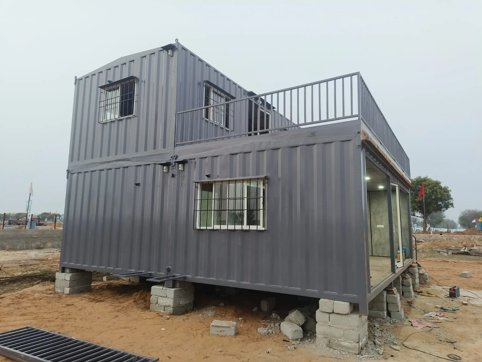 Container farm house under construction, steel structure with windows fitted