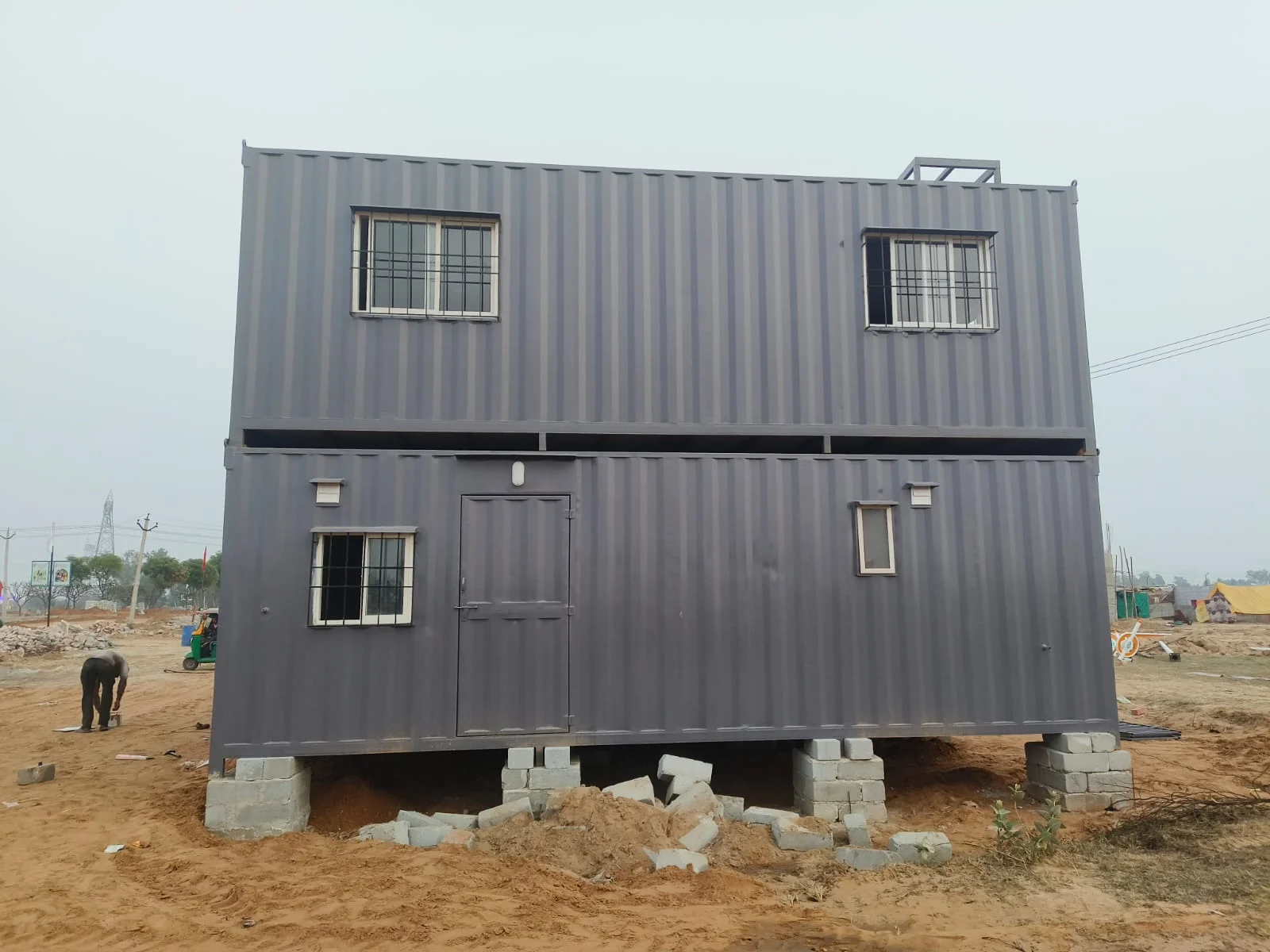 Two-storey container farm house structure on-site before finishing