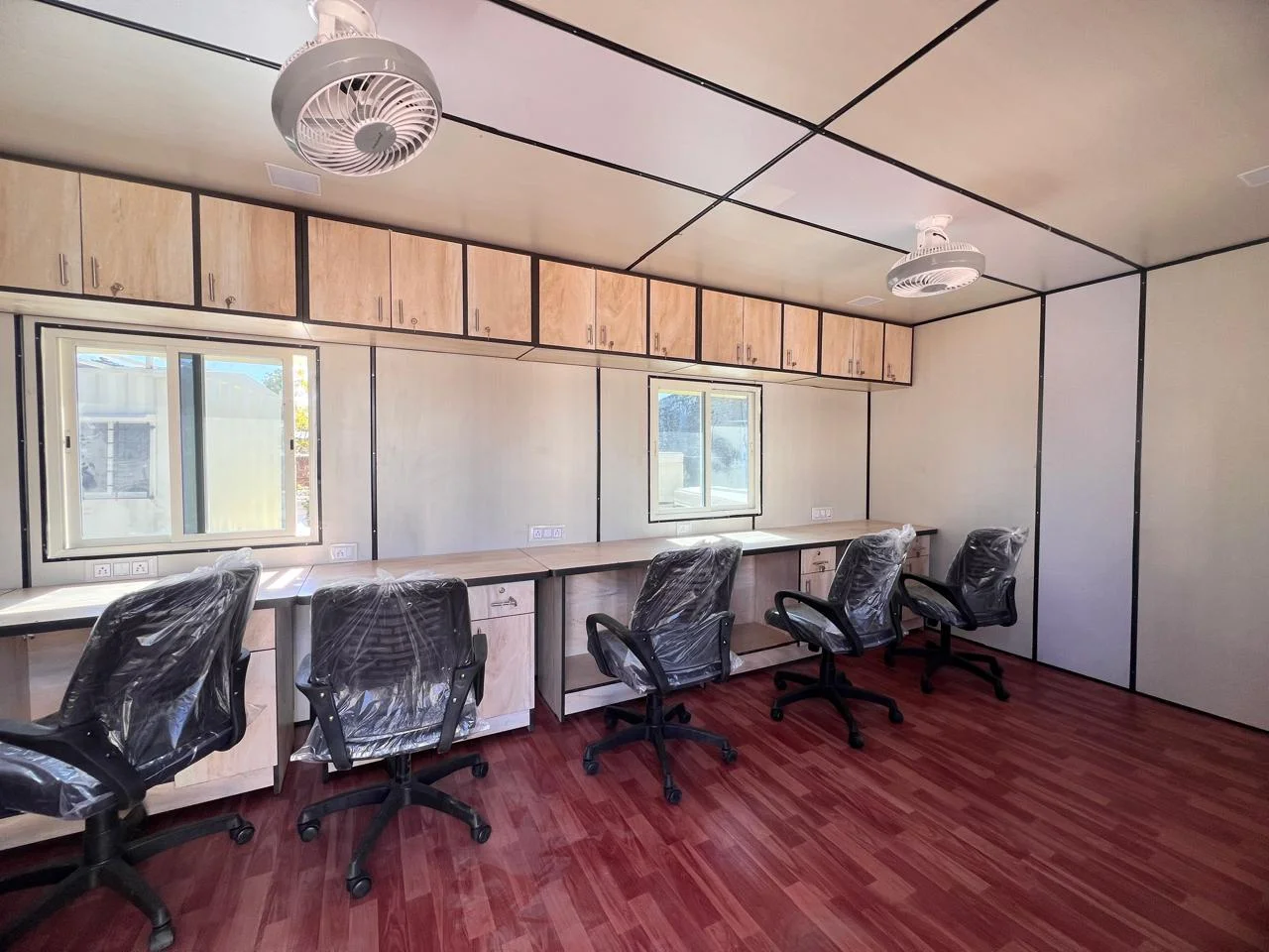 Fitted-out multi-desk office interior inside the CabinWala site office complex