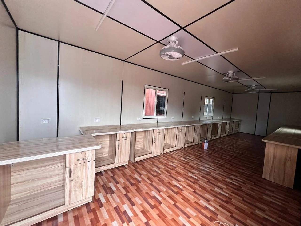 Long fitted office counter and workstations inside the site office complex